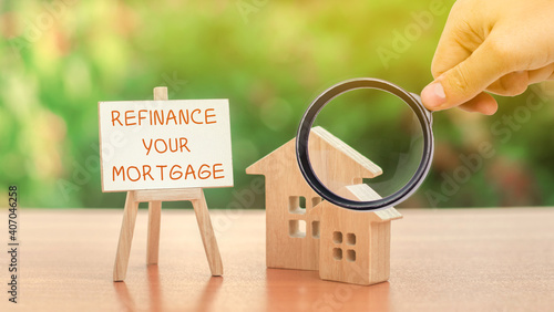 Inscription Refinance your mortgage and miniature houses. Real estate, finance and business concept. Interest rates. Property financing concept photo