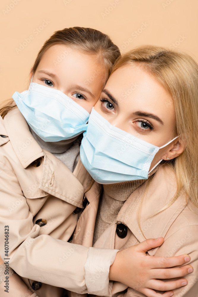 view of  mother and daughter in medical masks 