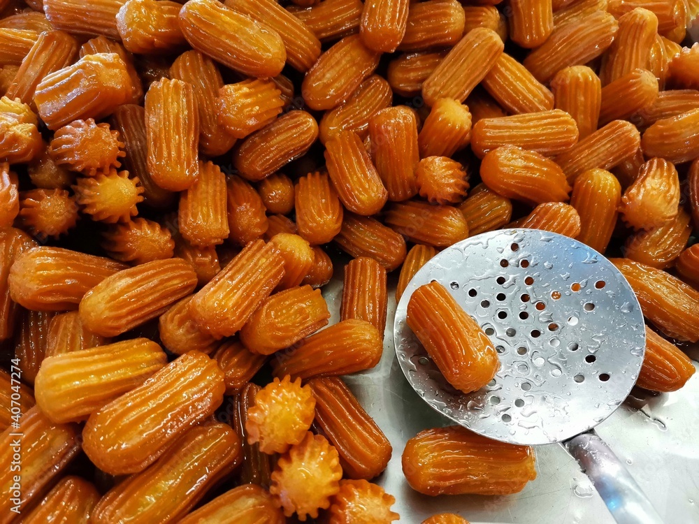 Fototapeta premium Turkish deserts. Tulumba dessert. Ramadan dessert. Sweet with syrup.