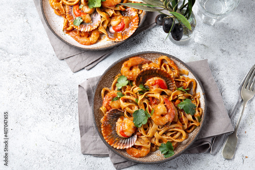 Mediterranean food. Seafood pasta with ostions and shrimps. White background. Top view photo