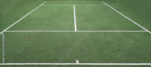 Empty and netless outdoor grass tennis court