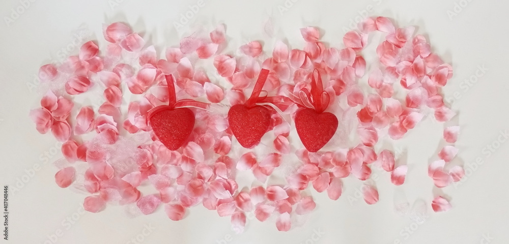 Three Red Hearts with Pink Petals on White Three Red Hearts with Pink Petals on White