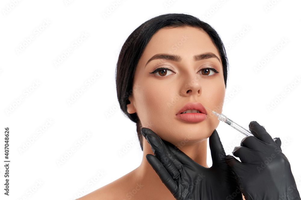 Beautician doing beauty injection for charming woman Beautician doing beauty injection for charming woman