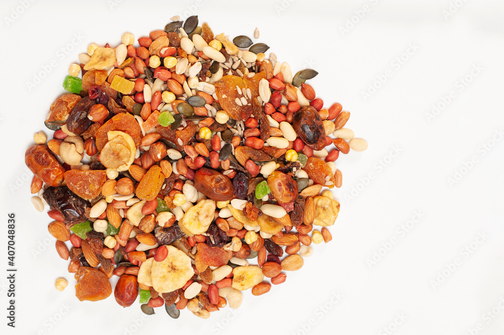 On a light background, various dried fruits - bananas, raisins, apricots, dates and nuts, sunflower seeds and pumpkin seeds On a light background, various dried fruits - bananas, raisins, apricots, dates and nuts, sunflower seeds and pumpkin seeds