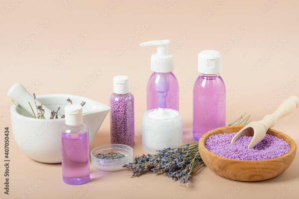 set of cosmetics with lavender on a beige background set of cosmetics with lavender on a beige background