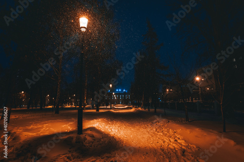 Snowy winter evening on the street with a lantern