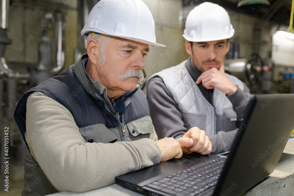 two engineers working on a laptop