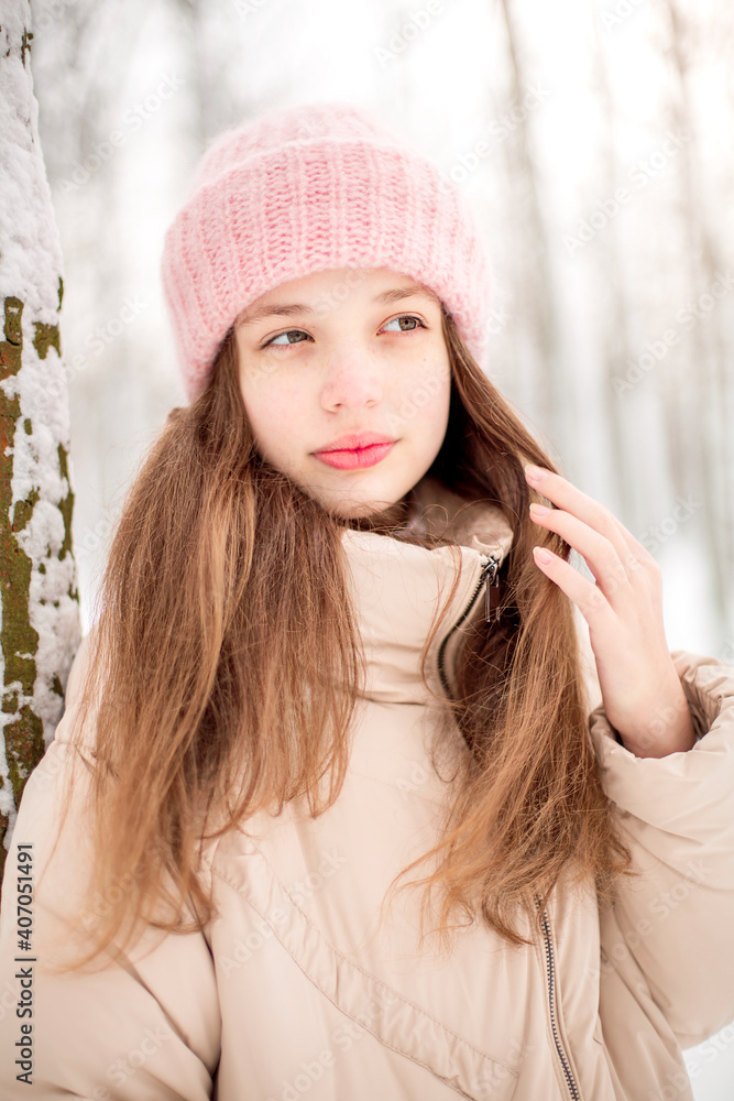A winter portrait of a girl smiling. Image with selective focus and toning A winter portrait of a girl smiling. Image with selective focus and toning