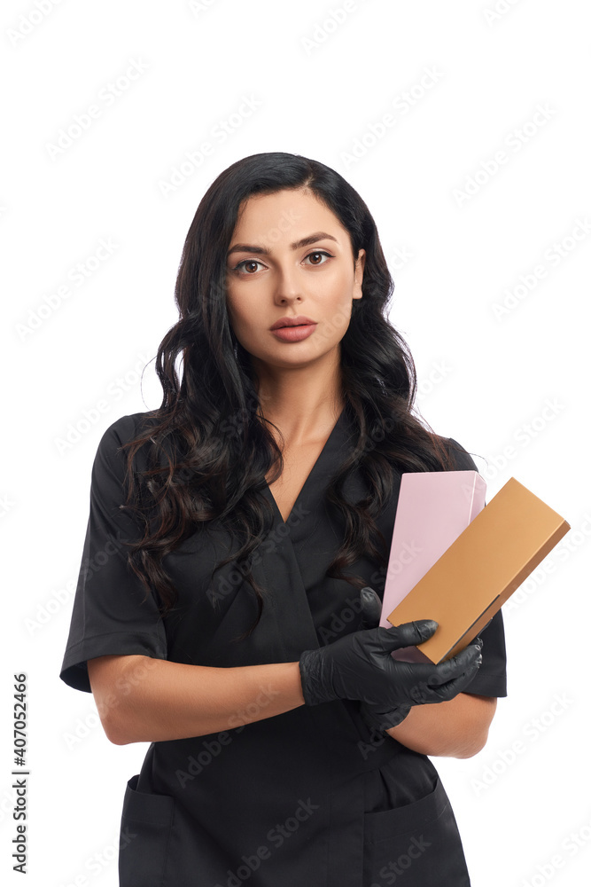 Doctor in black uniform and gloves holding cosmetic boxes Doctor in black uniform and gloves holding cosmetic boxes