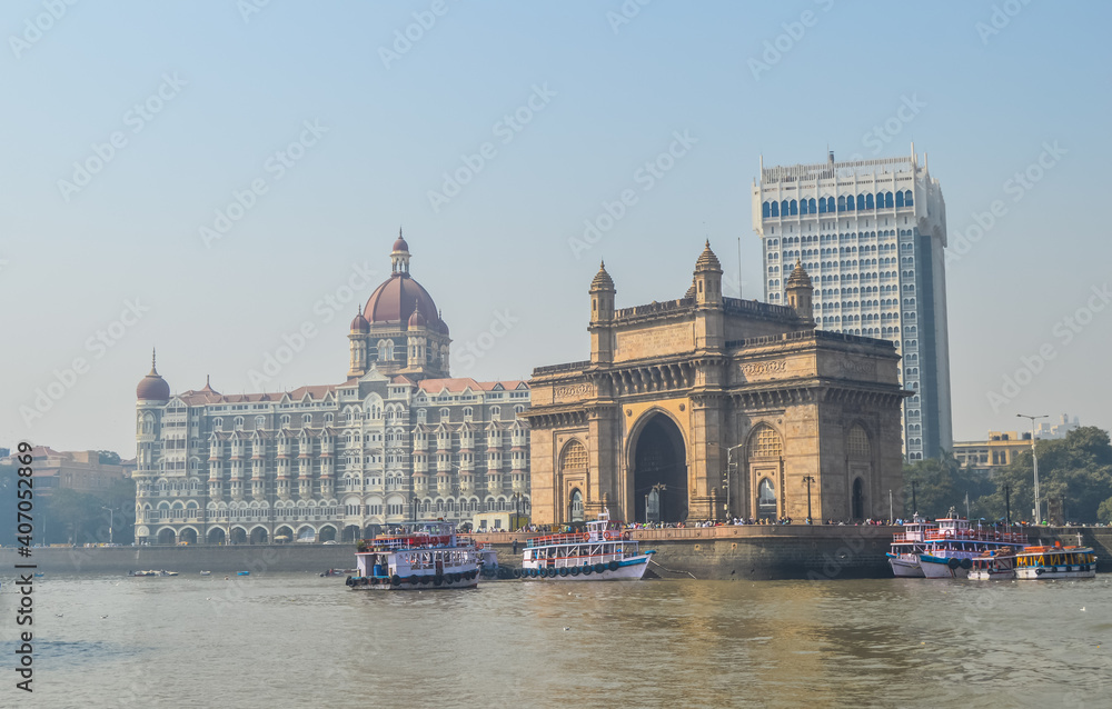 Beautiful Gateway of India near Taj Palace hotel on the Mumbai harbour with many jetties on Arabian sea