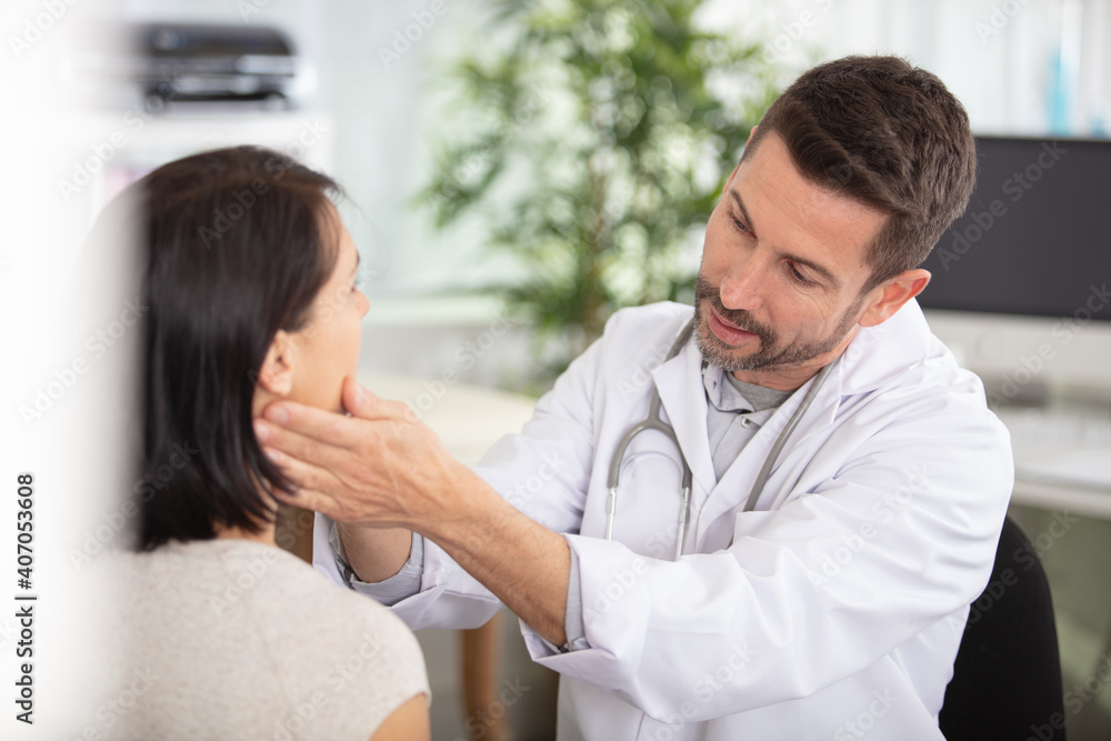 mature male doctor communicating with female patient in hospital mature male doctor communicating with female patient in hospital