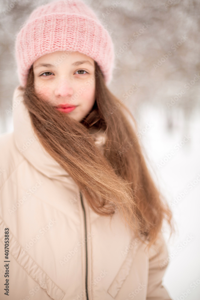 A winter portrait of a girl smiling. Image with selective focus and toning A winter portrait of a girl smiling. Image with selective focus and toning