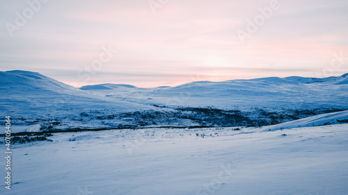 winter landscape with snow, with the sun just settling