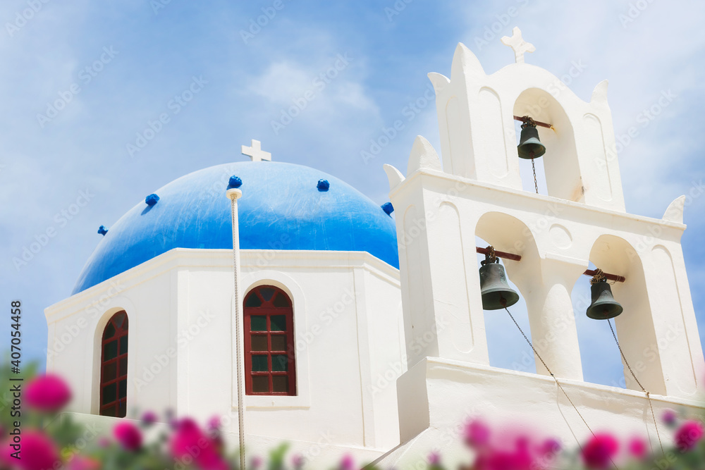 Famous beautiful Orthodox church with blue dome in Oia on Santorini island, Greece