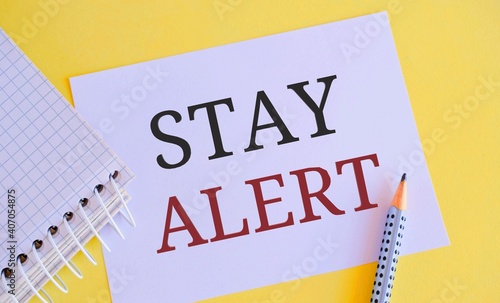 Stay alert text writen on white paper. Concept meaning Paying full attention to things around Quick to see or understand