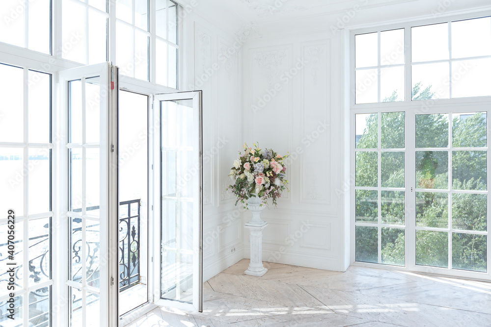 Fototapeta premium chic white huge spacious hall with a minimum of expensive antique furniture. Baroque interior design with ornament on the walls and parquet on the floor.