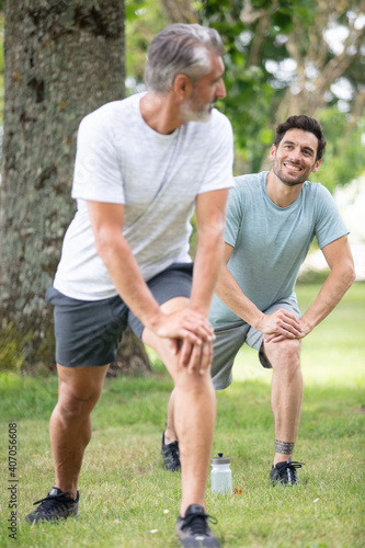 happy father and son jogging together in park