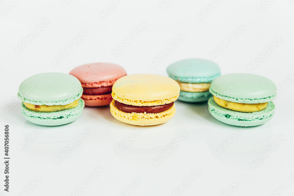 Sweet almond colorful pastel pink blue yellow green macaron or macaroon dessert cake isolated on white background. French sweet cookie. Minimal food bakery concept Copy space Sweet almond colorful pastel pink blue yellow green macaron or macaroon dessert cake isolated on white background. French sweet cookie. Minimal food bakery concept Copy space