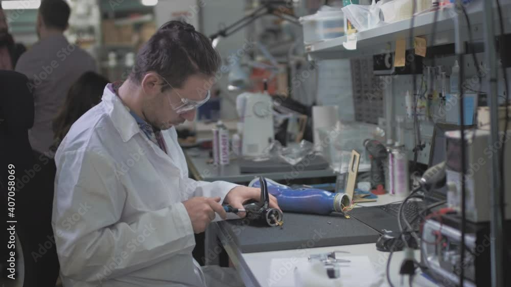 custom made wallpaper toronto digitalA scientist engineer creates or diagnoses a robotic arm prosthesis. Prosthetic laboratory, industrial production. A mechanical arm for a fulfilling life. Creation of cybernetic limbs.