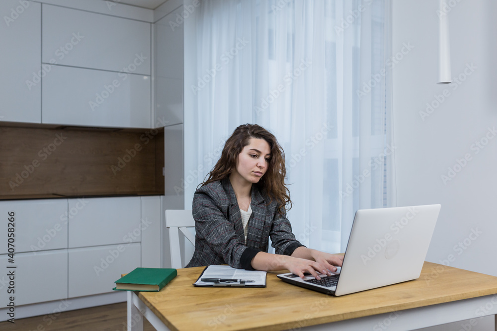 Beautiful female businessman working from home on laptop Beautiful female businessman working from home on laptop