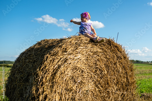 little child on a haystack