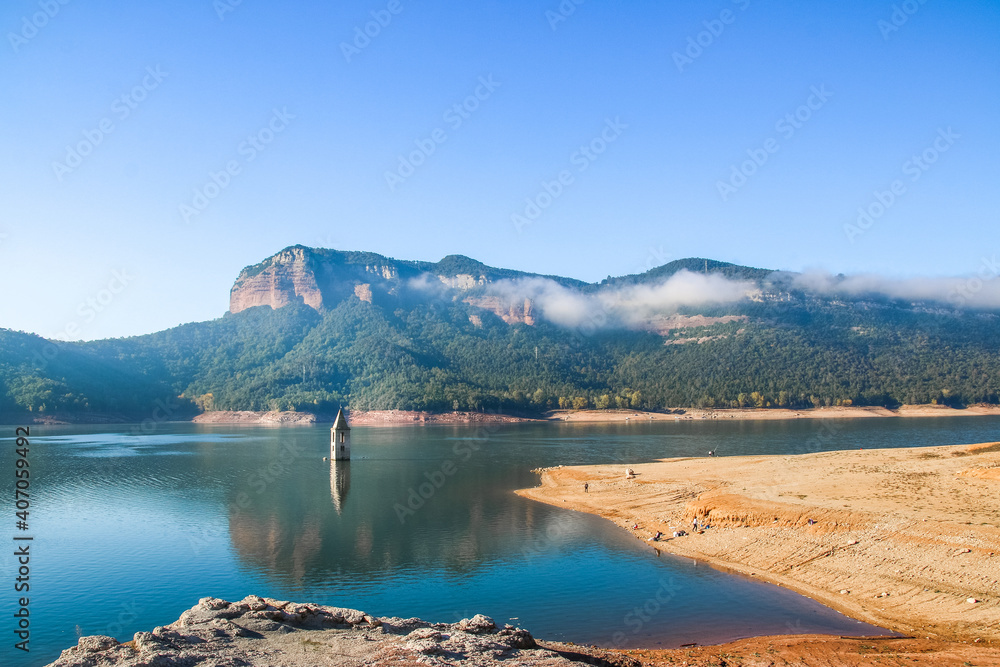 Sau Reservoir. Mountainous landscape of the Sau reservoir with its historic church in a sunny day. Tourism in Osona, Barcelona, Catalunya, Spain.