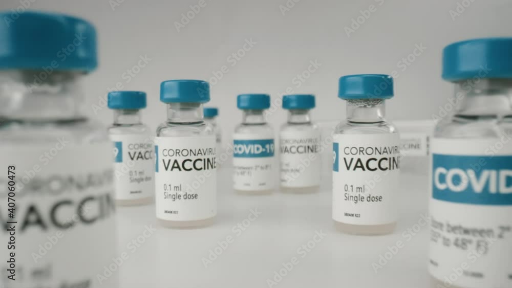 EXTREME CU MACRO DOLLY OUT view of bottles with vaccine for COVID-19 coronavirus cure. Concept of corona virus treatment, injection, vaccination, clinical trial during pandemic EXTREME CU MACRO DOLLY OUT view of bottles with vaccine for COVID-19 coronavirus cure. Concept of corona virus treatment, injection, vaccination, clinical trial during pandemic