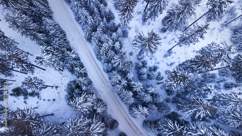 Aerial drone view of road in idyllic winter landscape.