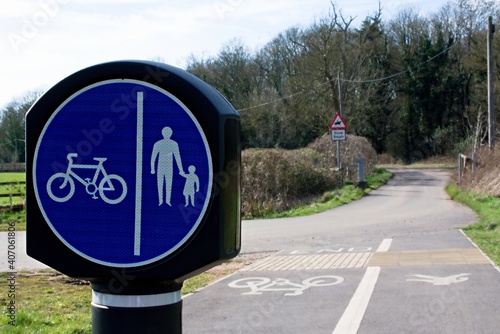 UK Circular shared cycling and walking sign with white text on a blue background. Room for text.