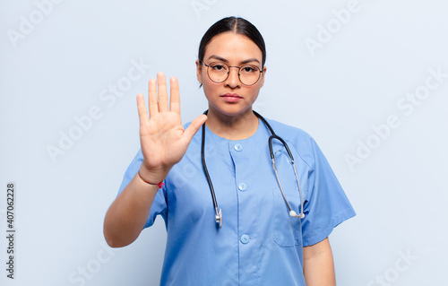 Canvastavla hispanic woman looking serious, stern, displeased and angry showing open palm ma