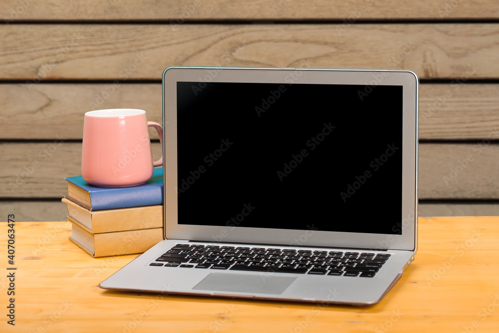 mocap Laptop with blank screen for product display and coffee on a wooden table. mocap Laptop with blank screen for product display and coffee on a wooden table.