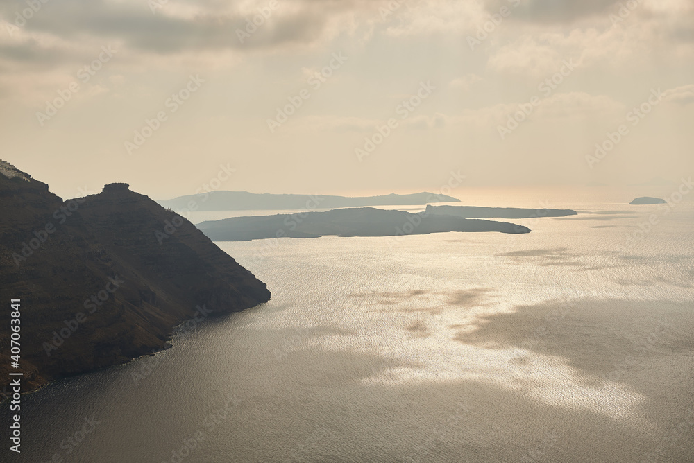 Sunset, subdued atmosphere of Santorini and the sea and mountains in the background