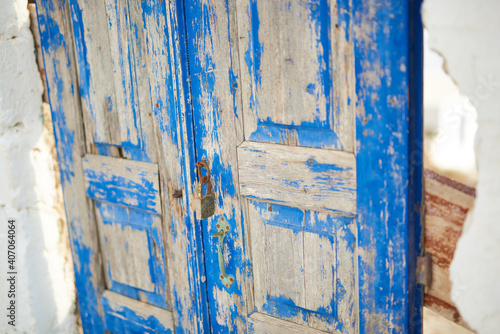 old door painted with blue paint © sebastiangora