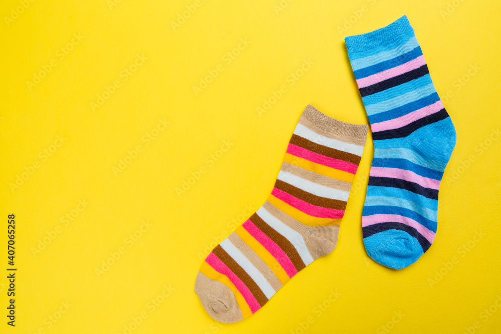 View from above. Socks are scattered on a yellow background. Clothing in the form of socks. View from above. Socks are scattered on a yellow background. Clothing in the form of socks.