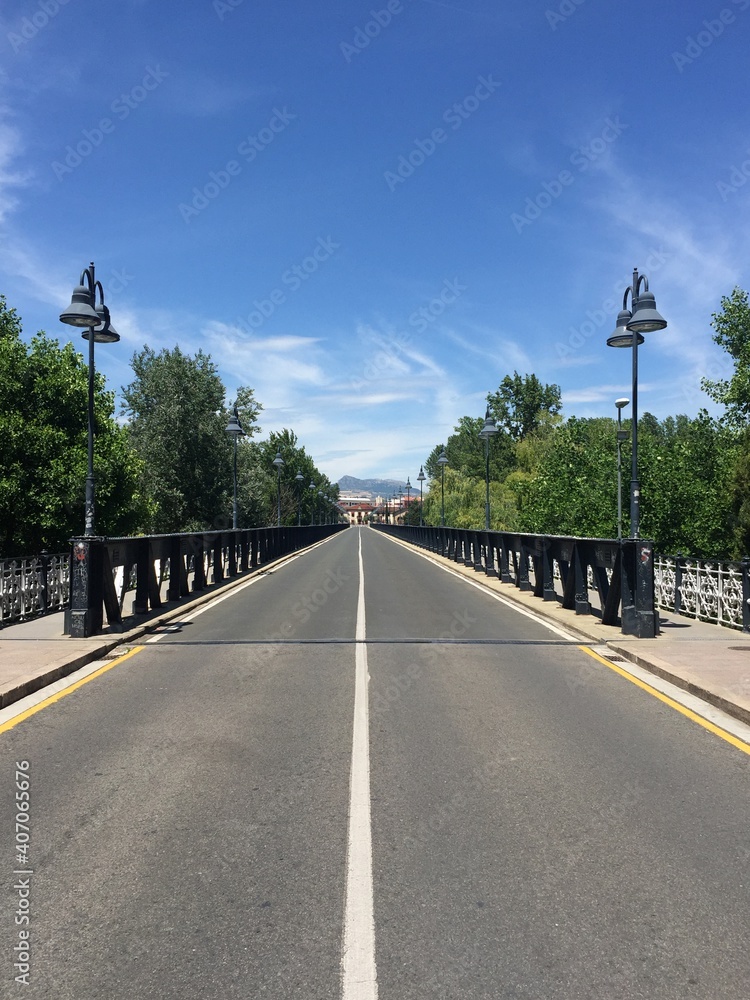 Road across a metal bridge stretching into the distance in the Spanish city of Logrono on June 22, 2019