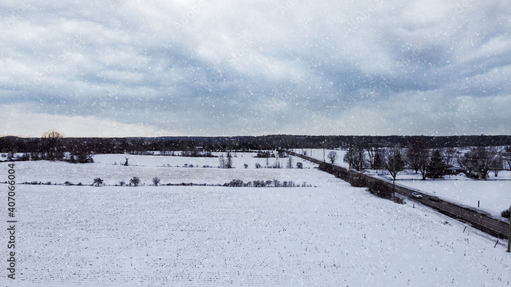 Aerial view of a corn field covered by snow, snow falling, dark mood, snow storm, near Huntmar Drive in Kanata, ottawa. Ottawa, Ontario, Canada