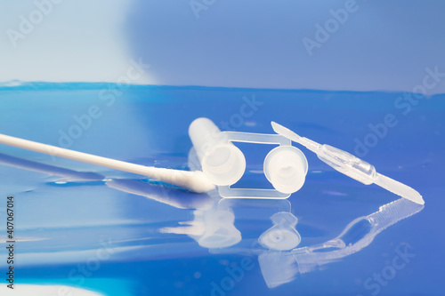 Testing kit for rapid detection of SARS-CoV-2 nucleocapsid protein antigen. Nasopharyngeal swab, extraction tube with dropper tip, sample extraction buffer on blue background