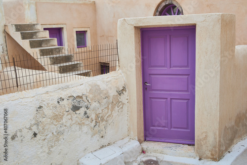 traditional greek village and white stone houses and purple vintage door