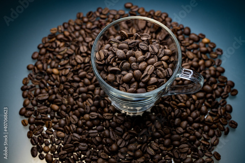  a cup of coffee among roasted coffee beans
