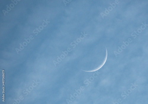 Waxing Crescent Moon In Cloudy Sky