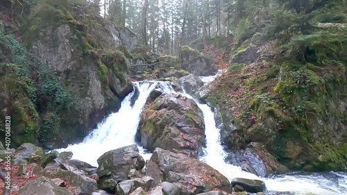 Petite Cascade waterfall in Tendon France, woodland area, slow motion medium shot photo