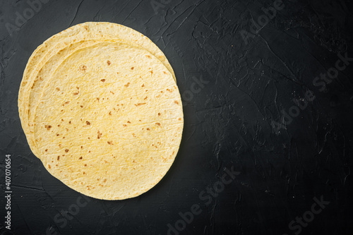 Mexican corn tortillas, on black background, top view flat lay with copy space for text