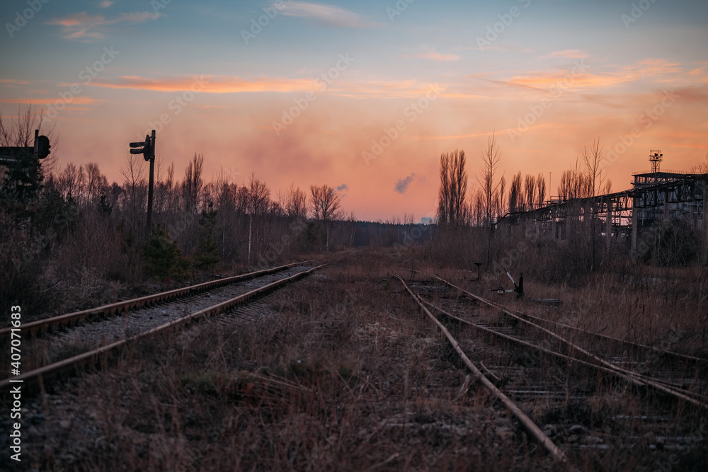 Fototapeta premium Old rusty abandoned railway at the sunset