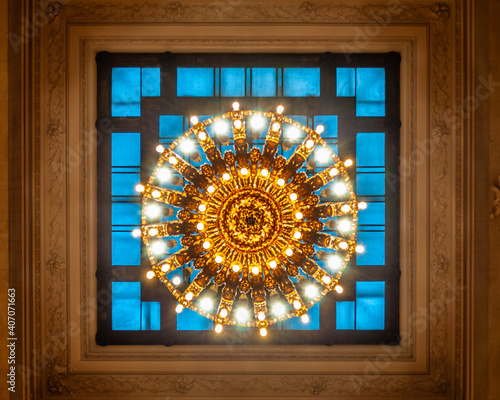 The concourse of the Grand Central Station lit by a globe-shaped chandelier in the Beaux-Arts style which contains 110 bulbs. Close up view.  Selective focus. Manhattan, New York, USA
