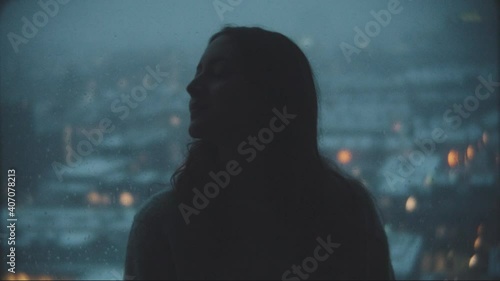 Woman thinking in front of her window photo