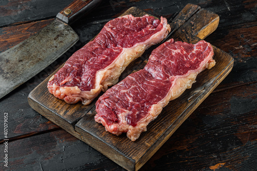 New york beef steak, on old dark wooden table background