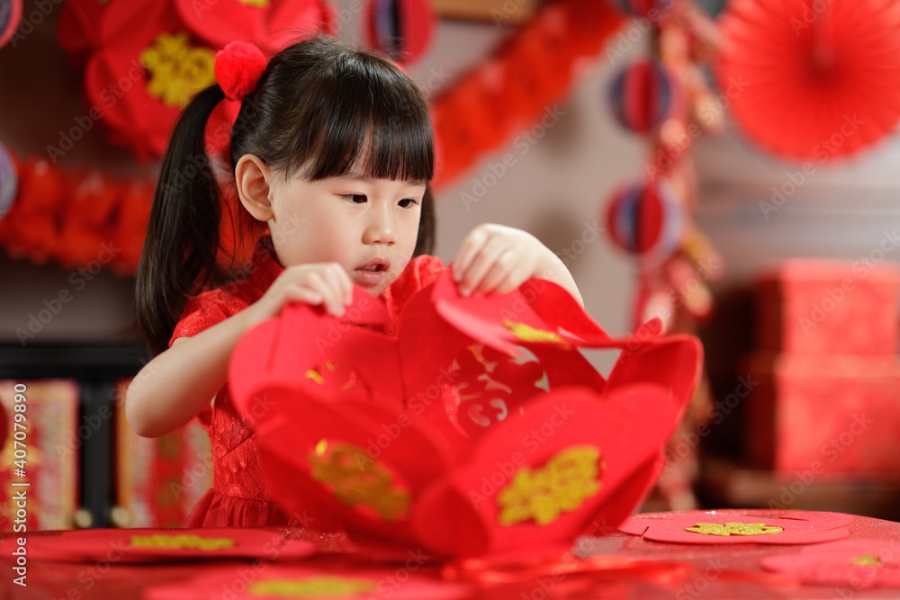 young chinese girl making traditional chinese FU means lucky lantern for celerating Chinese new year young chinese girl making traditional chinese FU means lucky lantern for celerating Chinese new year