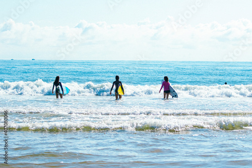 children surfing on the beach © Tamina