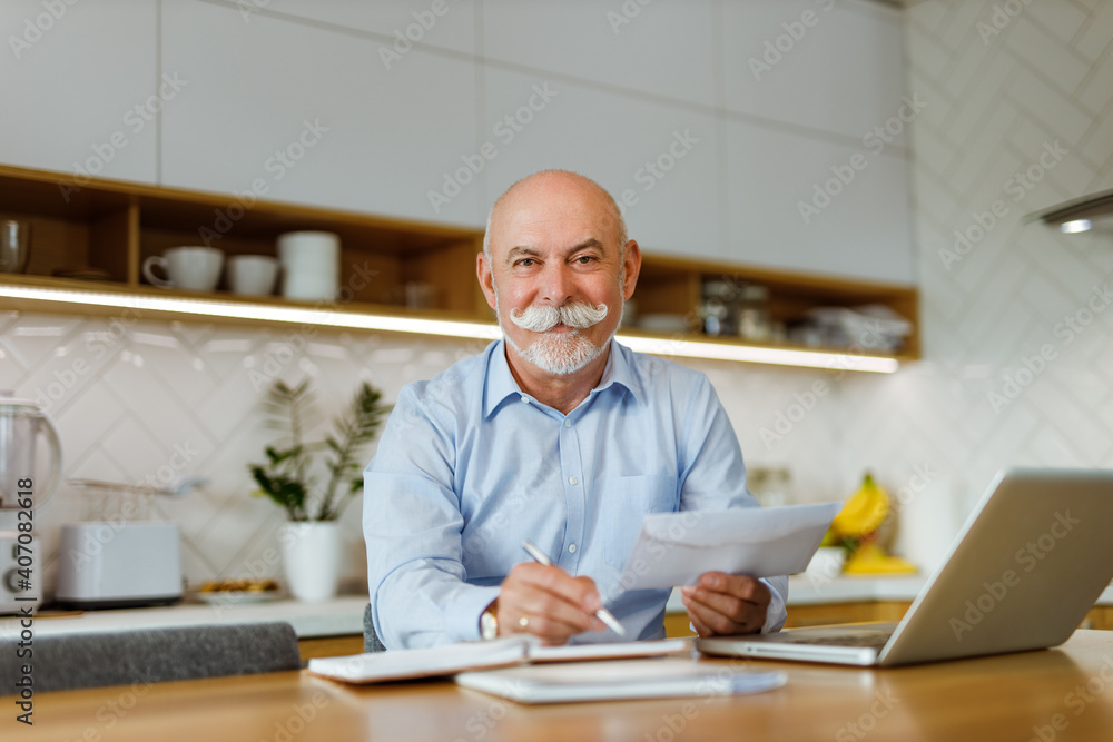 Mature man reading and holding document. Mature man reading and holding document.