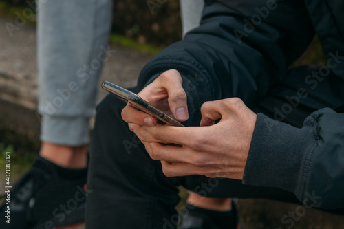 hands of young man with mobile phone